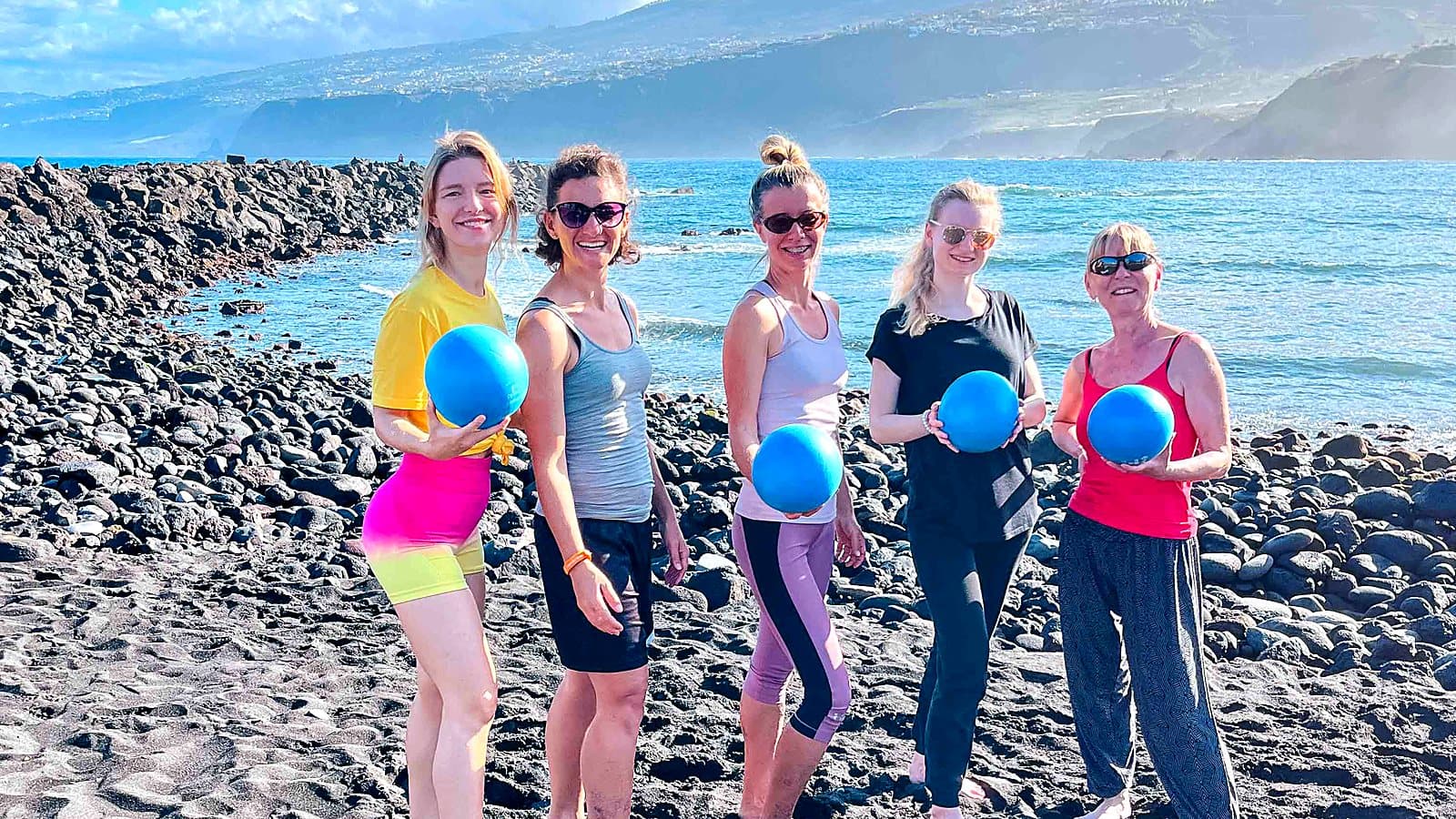 Participants with exercise balls on the shore in Tenerife